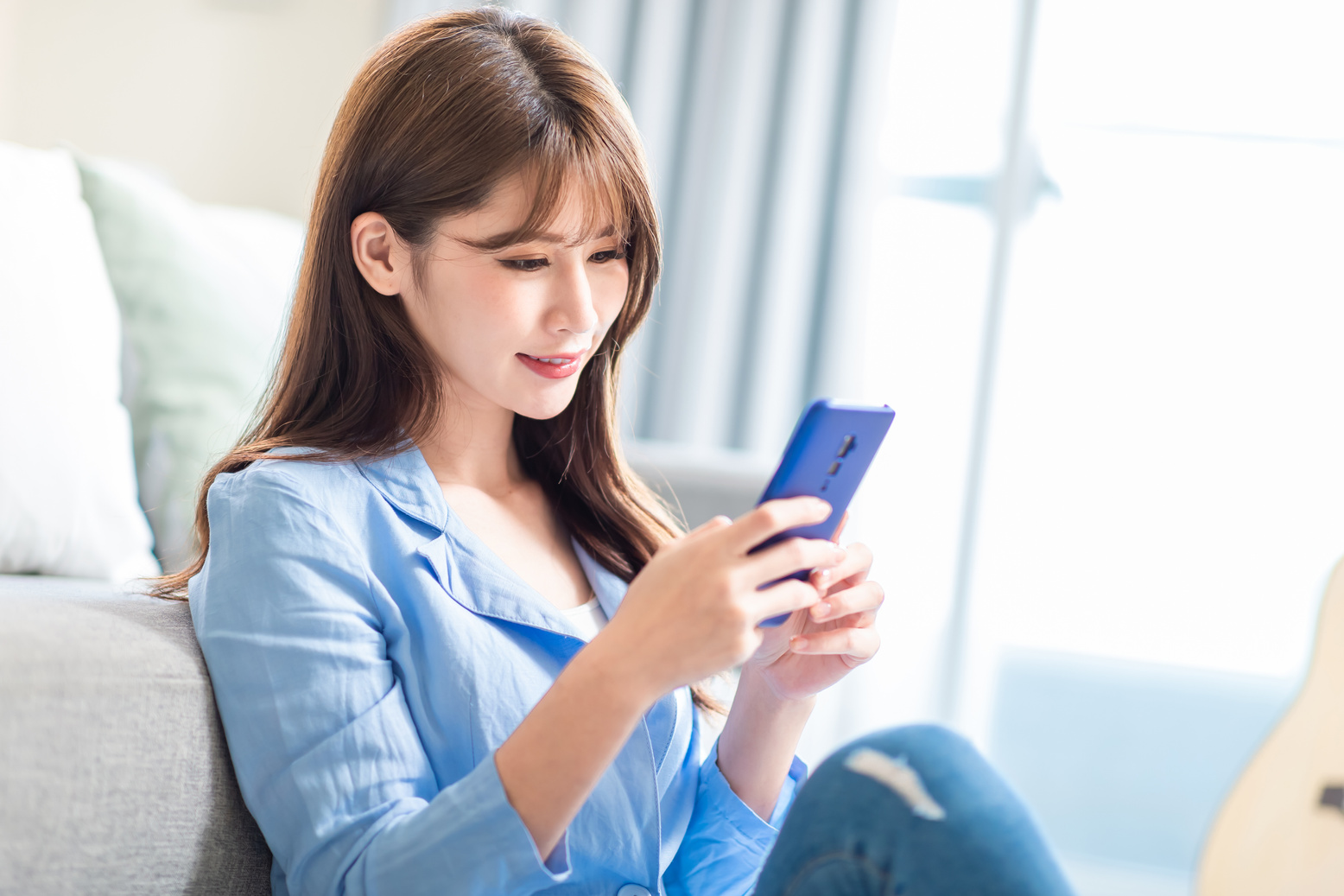 Woman Using Smartphone at Home